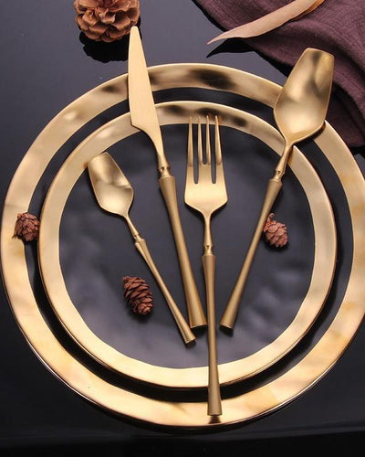 Golden cutlery on a golden plate