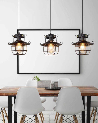 Three ceiling lamps with a cage shape hanging on top of a dining table in a white room