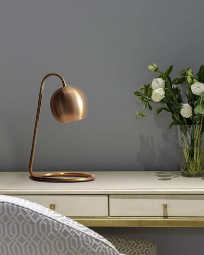 A copper lamp on a working desk
