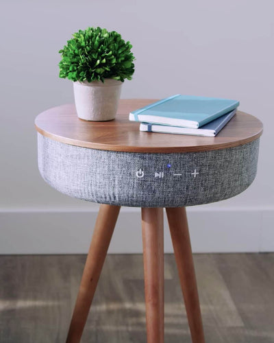 A smart coffee table of walnut wood with integrated bluetooth speakers, wireless charging and USB ports