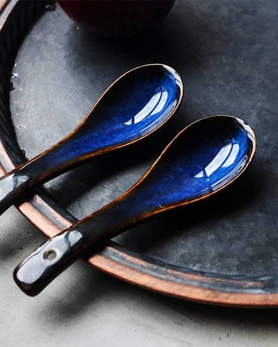 Two aoi blue spoons presented on a grey plate