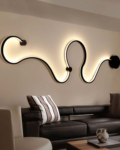 A wall lamp in a wave shape on the wall of a living room