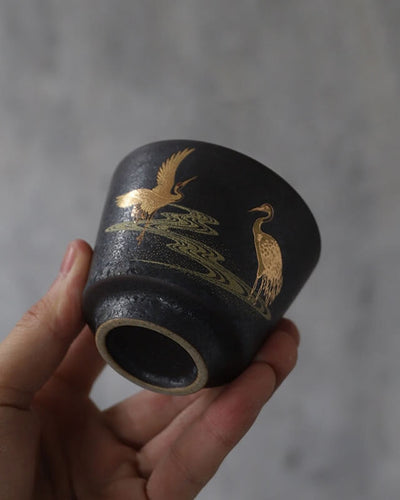 ZEN Ginza tea cup with golden painting showing two cranes in front of grey background